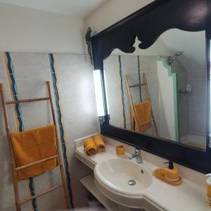 a bathroom with a sink and a mirror at Studio Kowosol en résidence de vacances in Sainte-Anne