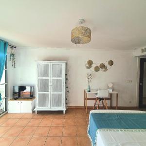 a bedroom with a bed and a table and a lamp at Studio vue sur mer en résidence de vacances in Sainte-Anne