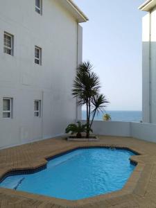 a large blue swimming pool next to a building at Breathtaking 3 Bedroom unit with amazing sea views in Ramsgate