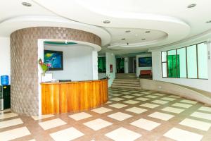 a lobby with a reception desk in a building at Hotel Galapagos Tortuga Bay in Puerto Ayora