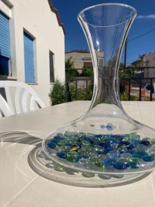 a glass vase filled with blue gems sitting on a table at Al Fresco Mare in Triscina