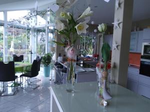 a kitchen with two vases with flowers on a counter at B&B on Top in Sirnach