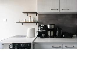 a kitchen with a coffee maker on a counter at Central faliro Apartment near to marina in Athens +13 photos