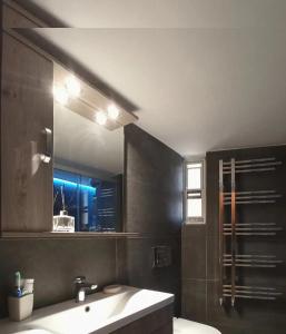a bathroom with a sink and a mirror at Central faliro Apartment near to marina in Athens