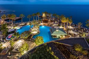 an aerial view of a resort pool at night at Royal Savoy - Ocean Resort - Savoy Signature in Funchal