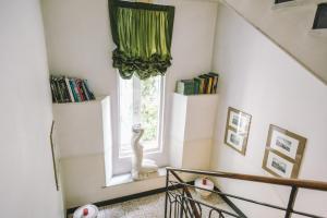 a room with a window with a statue in front of it at Eveline Portosole Hotel in Sanremo