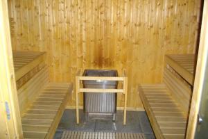 a sauna with two beds and a table in it at Family villa at 1H15 from Lyon in Prétieux