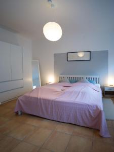 a bedroom with a large bed with a pink blanket at Ferienwohnung auf dem Kore in Kirkel