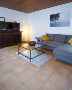 a living room with a couch and a table at Ferienwohnung auf dem Kore in Kirkel