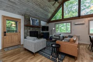a living room with two chairs and a fireplace at Star View Cabin - Powder Horn Mountain in Powderhorn Mountain