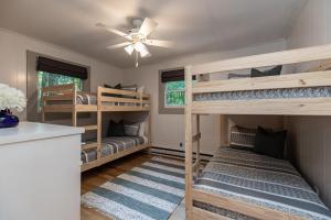 a room with three bunk beds and a ceiling fan at Star View Cabin - Powder Horn Mountain in Powderhorn Mountain +57 photos