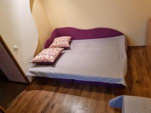 a bed in a room with two pillows on it at Apartment Maya in Visaginas