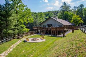 a large house with a deck and a fire pit at Moonlight Ridge - Powder Horn Mountain in Powderhorn Mountain