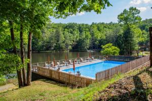 a swimming pool next to a body of water at Moonlight Ridge - Powder Horn Mountain in Powderhorn Mountain