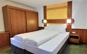 Postel nebo postele na pokoji v ubytování Hotel Garni Belvedere