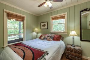 a bedroom with a bed and a ceiling fan at Twin Creeks Cabin - Anglers Retreat! in Powderhorn Mountain
