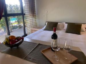 a room with a bed with a bowl of fruit and wine glasses at YHFlorence - con piscina privata uso esclusivo e hammam in Florence