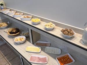 a buffet line with many different types of food at Europa Hotel Brasília by Bsb Inn in Taguatinga