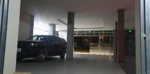 a black truck parked in front of a building at THANH XUÂN HOTEL in Cao Bằng