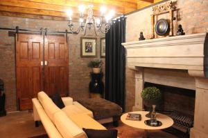 a living room with a couch and a fireplace at Furrows Lodge in Nieu-Bethesda