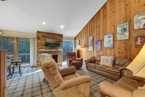a living room with a couch and chairs and a fireplace at Harbor Springs Retreat in Harbor Springs