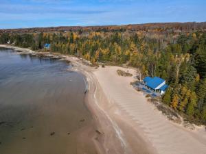 an aerial view of a house on a beach at Harbor Springs Retreat in Harbor Springs
