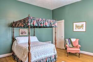 een slaapkamer met een hemelbed en een stoel bij Historic West Virginia Home Built in 1854! 