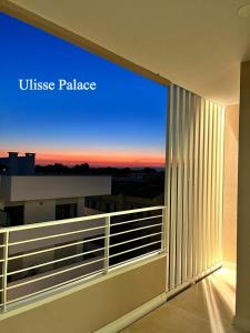 a balcony with a view of a sunset from a building at Ulisse Palace in Lido di Jesolo