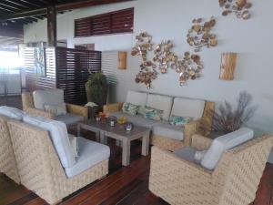 a living room with couches and a table at La Sagesse Hotel, Restaurant and Beach Bar in Content