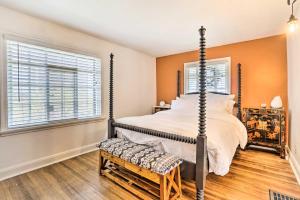 a bedroom with a four poster bed and a window at Welcoming Columbus Retreat 5 Mi to Downtown! in Columbus