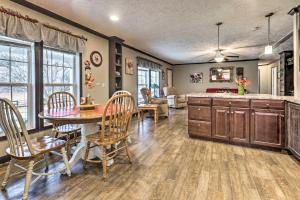 a kitchen and living room with a table and chairs at Lovely Sadieville Retreat with Deck and Grill! in Corinth