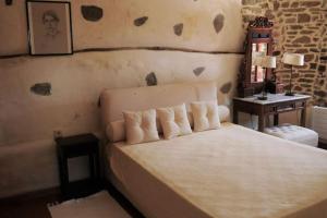 a bedroom with a bed and a side table at Wonderful 4 Bedroom Villa & separate guest house Villa Thalia in Zagora