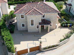 an aerial view of a house with a tile roof at Villa NOAH - 4 bedrooms, 4 bathrooms, heated inside pool, jacuzzi, sauna, gym in Kornić