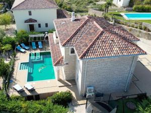 an aerial view of a house with a swimming pool at Villa NOAH - 4 bedrooms, 4 bathrooms, heated inside pool, jacuzzi, sauna, gym in Kornić