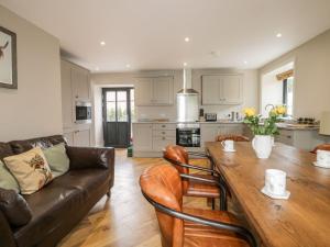 a living room with a couch and a wooden table at Fox's Den in Hull