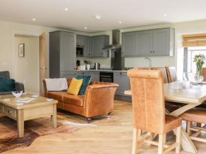 a kitchen and living room with a table and chairs at Partridge Place in Hull