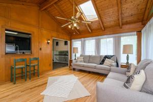 a living room with a couch and a ceiling fan at Enjoy This Roomy Cabin Style 5BR With A Pool Table in Marietta