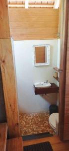 a bathroom with a sink and a toilet at RAIATEA - The BEACH HOUSE - plage sur le lagon ! in Tevaitoa