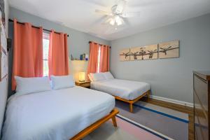 a bedroom with two beds and a ceiling fan at Plan A Trip To Georgia Aquarium In This Comfy 3BR in Atlanta