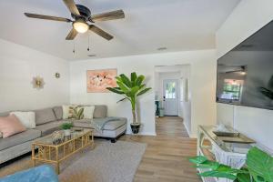 a living room with a couch and a ceiling fan at Refreshing Gulfport Escape Boat, Fish and More in St. Petersburg