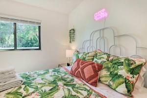 a bedroom with a bed with a tropical bedspread at Refreshing Gulfport Escape Boat, Fish and More in St Petersburg