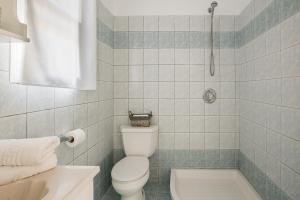 a bathroom with a toilet and a tub and a shower at Eagle's Nest in Lourdhata