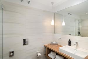 a bathroom with a sink and a mirror at elaya hotel regensburg city center in Regensburg