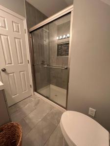 a glass shower in a bathroom with a toilet at 1Guest House Baltimore County (own room, Joppa RD) in Parkville