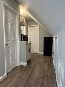 a kitchen with a white door and a black refrigerator at 1Guest House Baltimore County (own room, Joppa RD) in Parkville