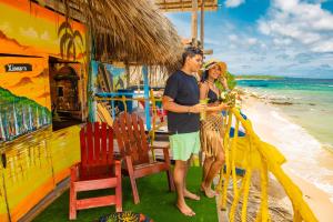 a man and a woman standing on the beach at Nuestros Tres Tesoros II in Playa Blanca