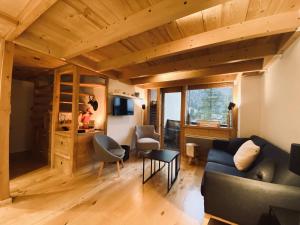 a living room with a couch and a table at Residence Grand Roc - Kercham in Chamonix-Mont-Blanc