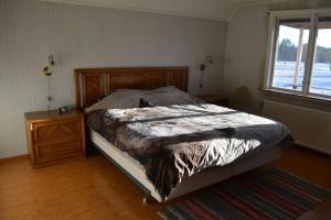 a bedroom with a bed and a dresser and a window at Countryside Holiday home "Our Little Farm" in Hagfors