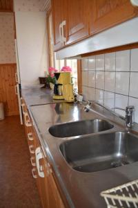 a kitchen with a sink and a counter top at Countryside Holiday home "Our Little Farm" in Hagfors