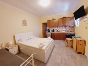 a small bedroom with a bed and a kitchen at George studios 1 in Ipsos